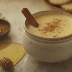 Creamy golden milk in a ceramic mug, garnished with cinnamon stick and turmeric powder, showcasing the rich color of this comforting golden milk recipe.