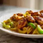 A bowl of Creamy cajun chicken pasta with bell peppers and parmesan.