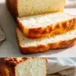 A tall, freshly baked gluten free bread recipe sandwich loaf with a deeply crackly golden-brown crust, sliced to reveal a soft, airy crumb, resting on a rustic wooden cutting board with scattered flour.