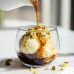 A clear glass showing how to make affogato with espresso and gelato.