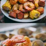 A dark sheet pan filled with a vibrant oven seafood boil recipe featuring glistening jumbo shrimp, steaming open clams, golden-brown sausage coins, and bright yellow corn on the cob, all generously drizzled with spiced garlic butter and garnished with fresh parsley.